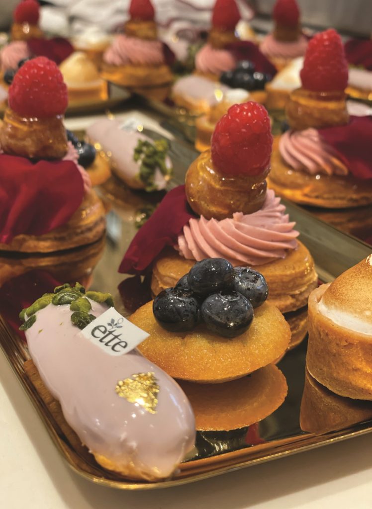 A tray of pastries with berries and raspberries.