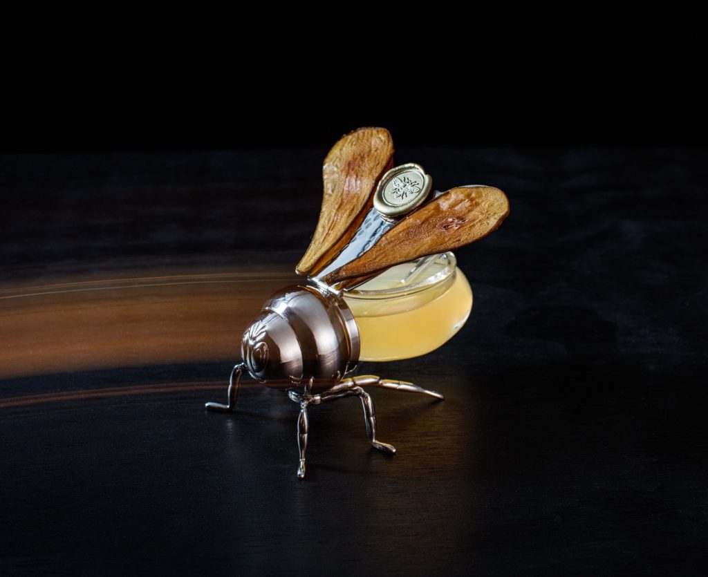A model of a bee along with a diel over it