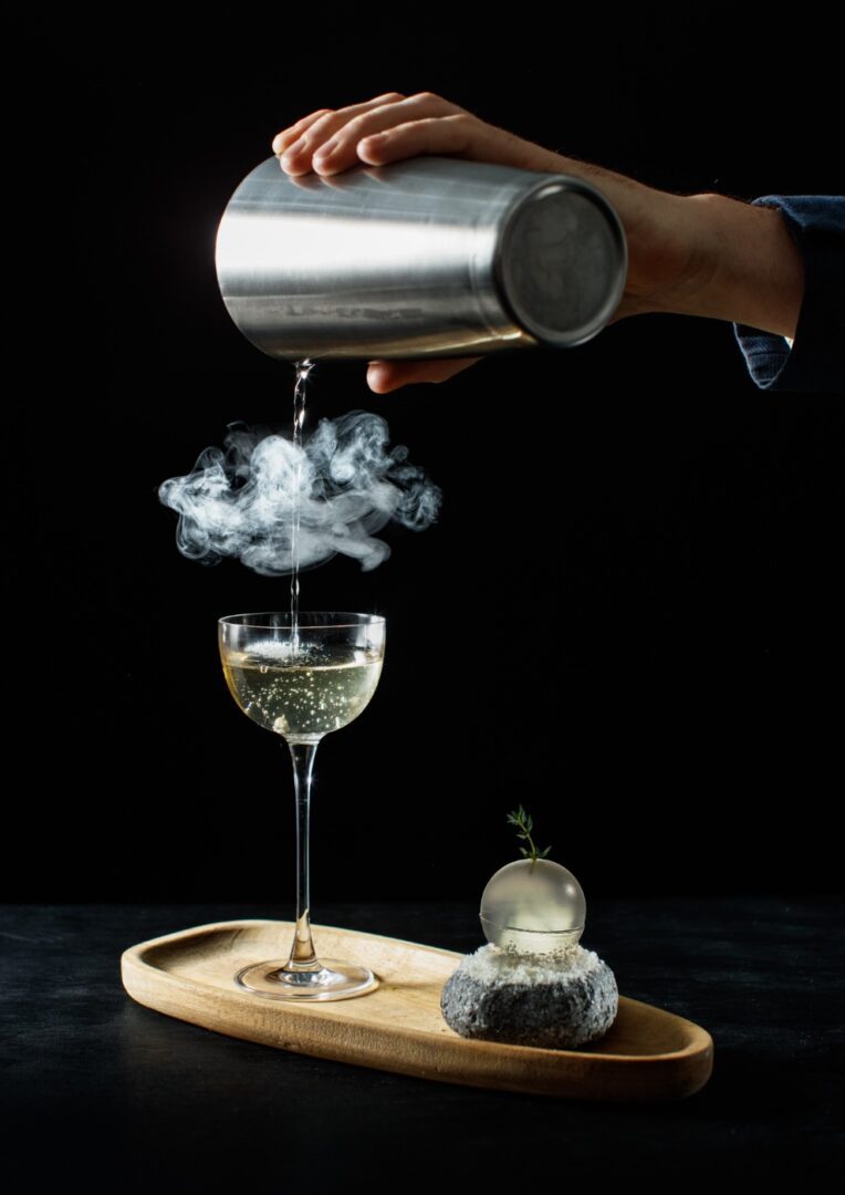 A person pouring wine into a glass