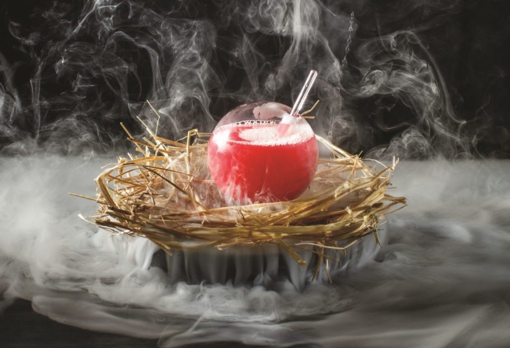 A red drink in a nest with smoke.