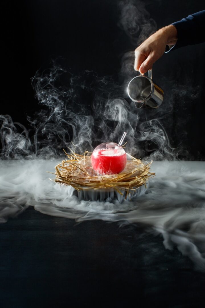 A person is pouring liquid into a candle.