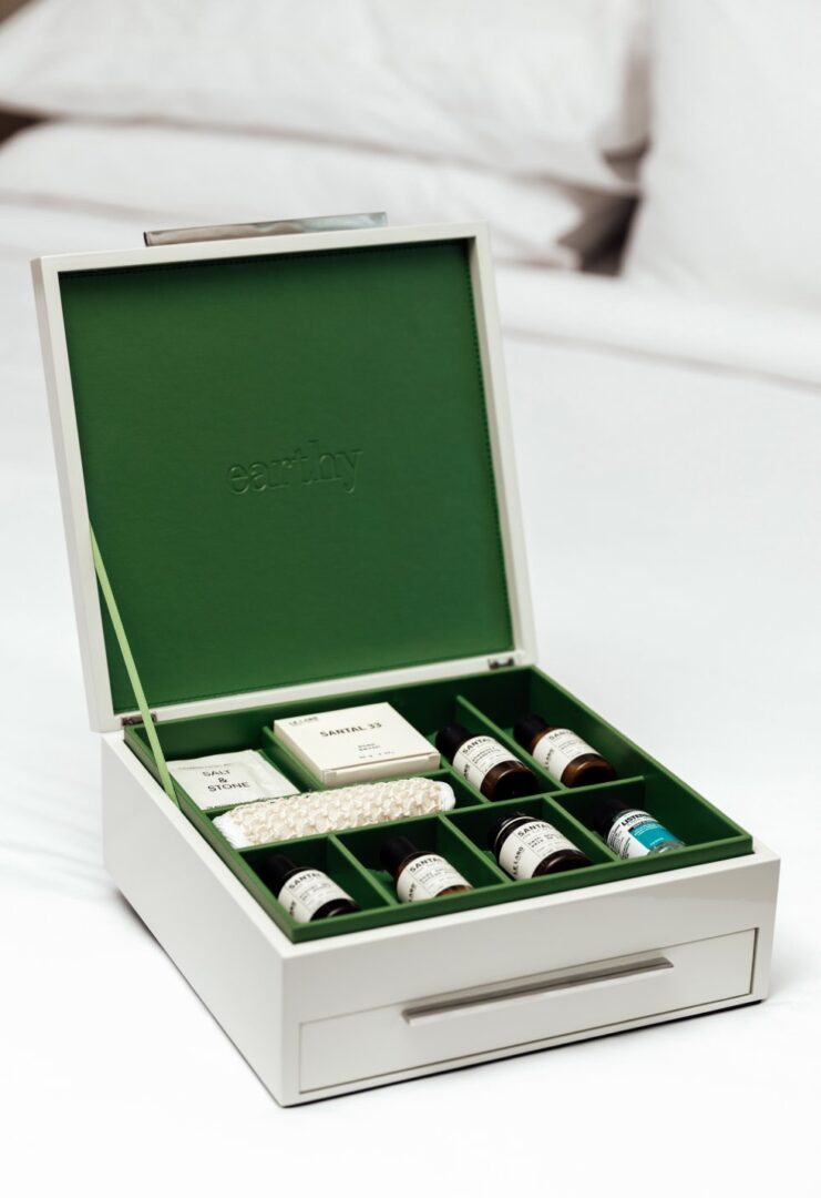 A white box with green lid and contents inside.