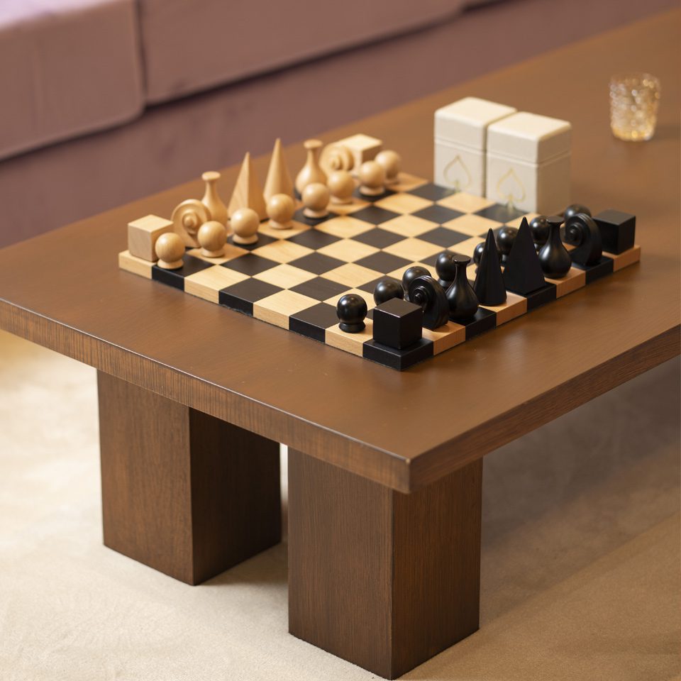 A coffee table with chess pieces on it