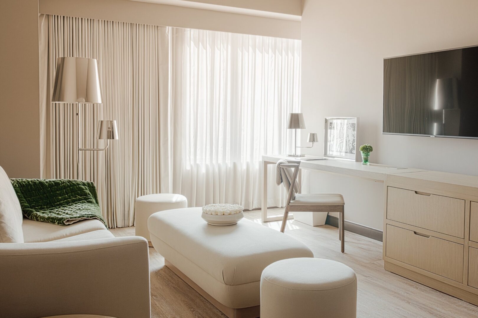 A living room with white furniture and curtains.