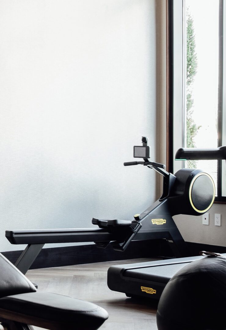 A rowing machine in the middle of a room.