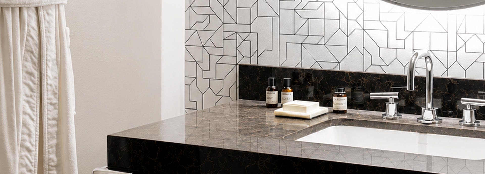 Bathroom vanity with dark stone countertop in the Timeless Suite at ette hotel