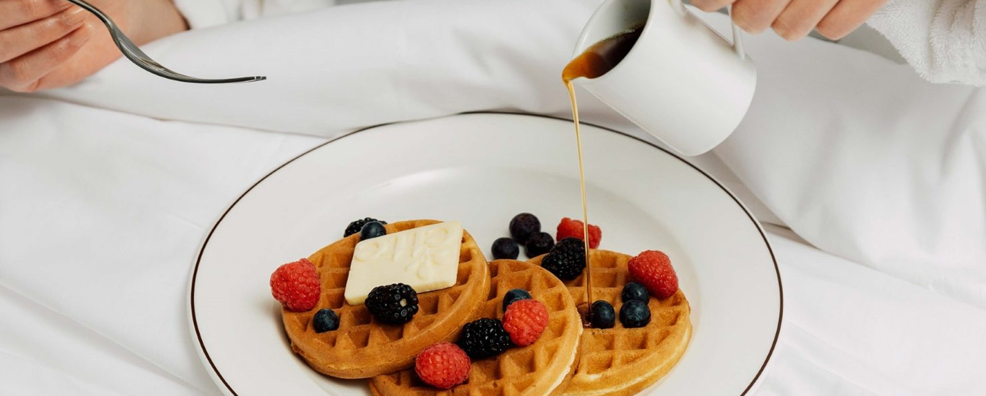 Waffle with fresh berries and syrup served in the Wellness Suite at ette hotel