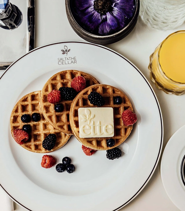 Waffles with fresh berries on a breakfast table