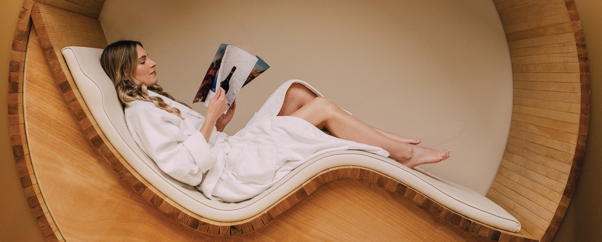 Guests relaxing in robes in the circular spa waiting lounge at ette hotel